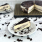 Velvety slice of Cookies & Cream Cheesecake with a thick layer of cookies and cream filling baked-in.