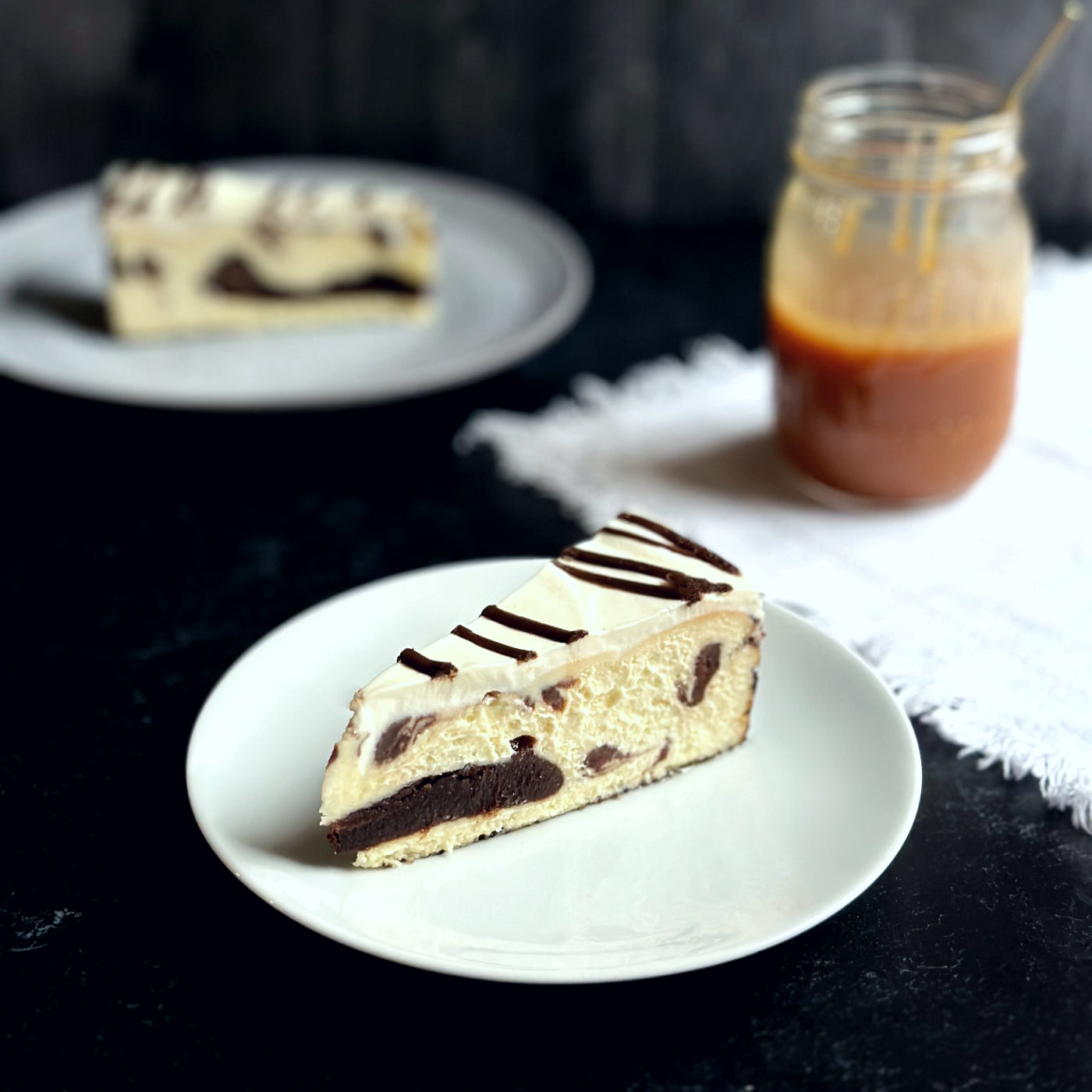 Velvety slice of Marble Brownie Swirl Cheesecake with layers of rich chocolate brownie batter baked-in.